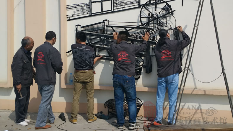 安徽無為凌宇電纜企業(yè)文化墻裝飾鐵畫&mdash;&mdash;徽藝坊師傅正在安裝鐵畫